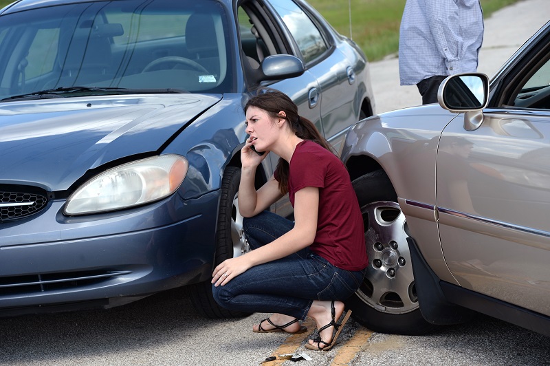 Young Woman Using Cellphone After Accident